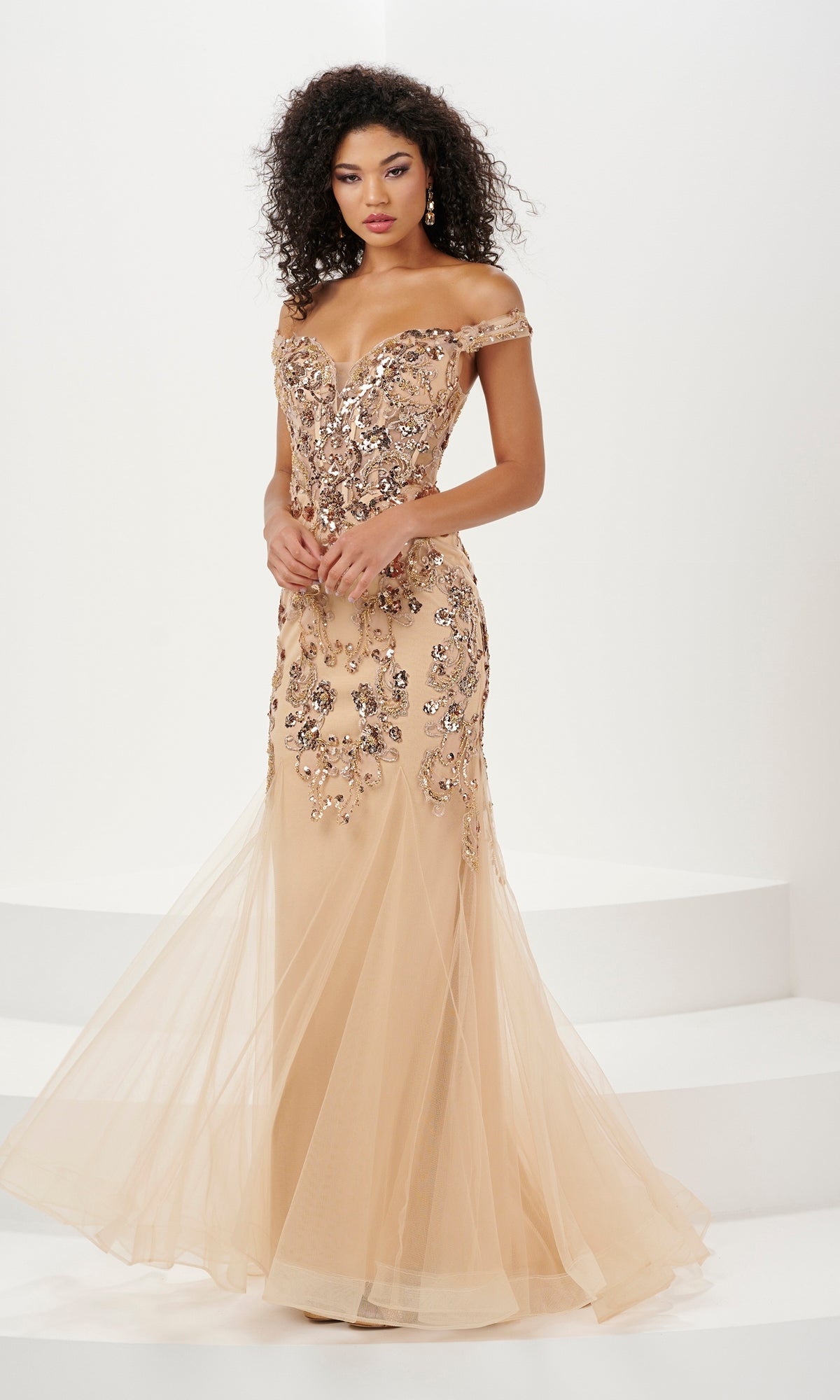 A woman stands on a white background wearing the Long Prom Dress 14185 by Panoply—an off-the-shoulder, floor-length mermaid dress with sequin embroidered floral embellishments.